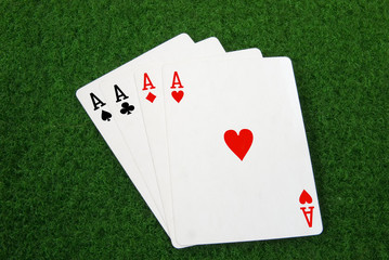 four aces on a green table