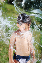Very cute child playing with water outdoor
