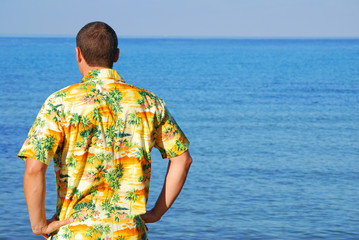 Man in hawaiian shirt looking out to sea