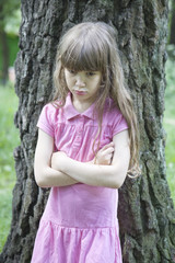 little cute angry girl seven years old standing at oaklll