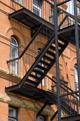 Fototapeta premium A fire escape on an old brick building