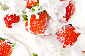strawberries falling in cream