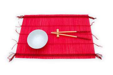 Chopsticks and bowl on the bamboo mat