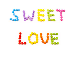 Inscription love from multi-coloured chocolate candy
