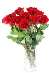 Red roses in a glass vase isolated