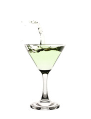 Green liquid splashing in a martini glass.