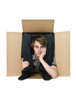 Acrobat inside of a cardboard box.