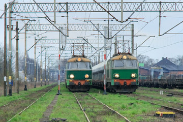 Freight trains with electric locomotives waiting at station