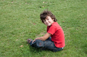 Happy child sitting on the grass