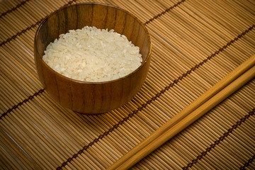white rice in bowl on wooden mat