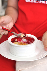 Woman eating cherry crumble