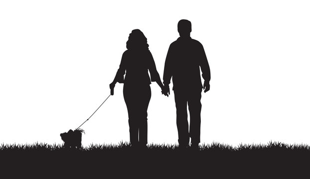 Silhouette Of A Couple Walking Their Dog