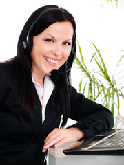 smiling brunette woman with headphone in office