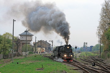 Obraz na płótnie Canvas Steam retro train starting from the station