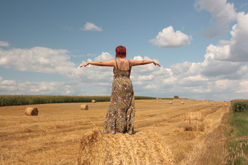 woman sitting in the middle of field