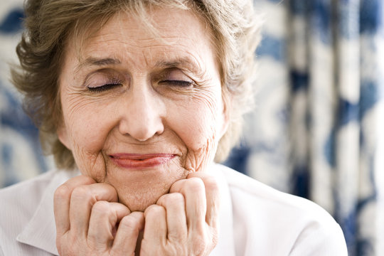 Closeup Of Hopeful Woman With Her Eye Closed