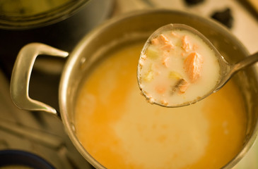 Laddle of freshly cooked fish soup