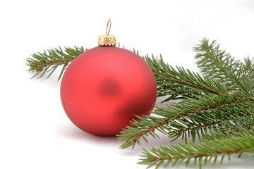 Obraz na płótnie Canvas Red christmas ball with the twig of the spruce