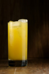 orange juice in a glass on a dark background