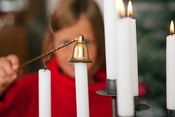 Child extinguishing Christmas candles