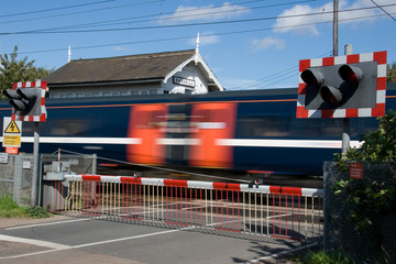 Train speeding through a level crossing