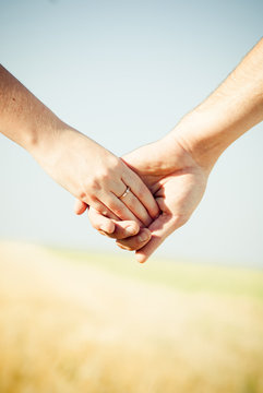 Close-up Holding Hands with Wedding Ring