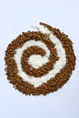 Spiral of coffee and white sugar on white