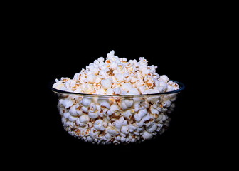 Bowl of popcorn on black background
