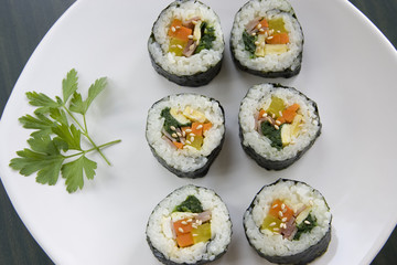 Some parsley leaves and Korean sushi.
