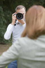 photographer takes a picture from woman