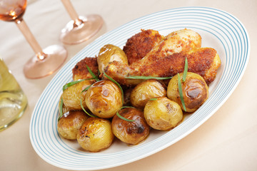 Roasted chicken legs with baked potatoes