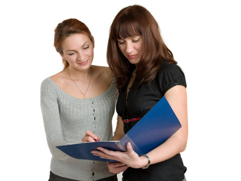 Two young women get acquainted oneself with the document.