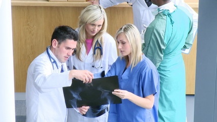High view of doctors studying an x-ray footage - Powered by Adobe