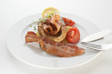 grilled carp fillet on organic potato with bacon and lemon