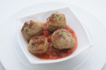 mince balls in bowl with tomato sauce