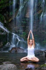 Yoga exercises near waterfall