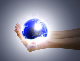 Human hands holding glowing planet - 16823737