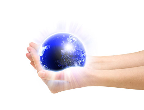 Human hands holding glowing planet