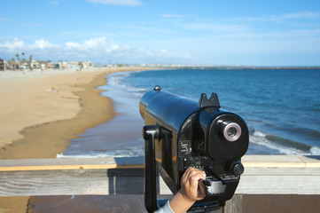 Child's hand on telescope