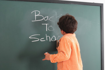 Preschooler at a chalkboard.