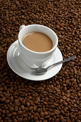 Cup with coffee, costing on coffee grain