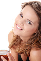 Young woman in bikini drinking ice tea