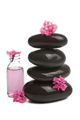 Obraz na płótnie Canvas spa stones with flowers and cosmetic bottle isolated