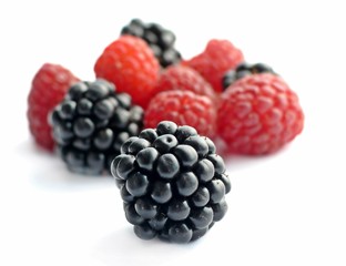 Blackberry and raspberry on white background