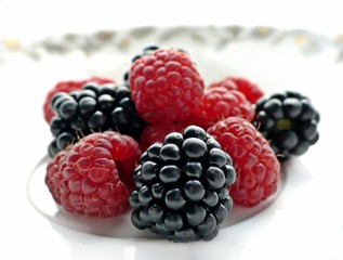 Blackberry and raspberry on white background