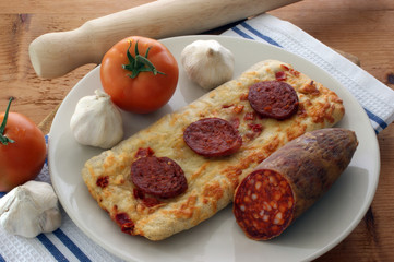 stone oven backed pizza with salami