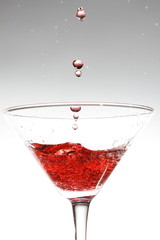 red cocktail on white
