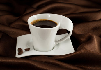 Cup of coffe on brown satin