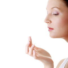 Obraz na płótnie Canvas Woman applying moisturizer cream on face