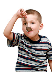 little boy with a spoon in mouth